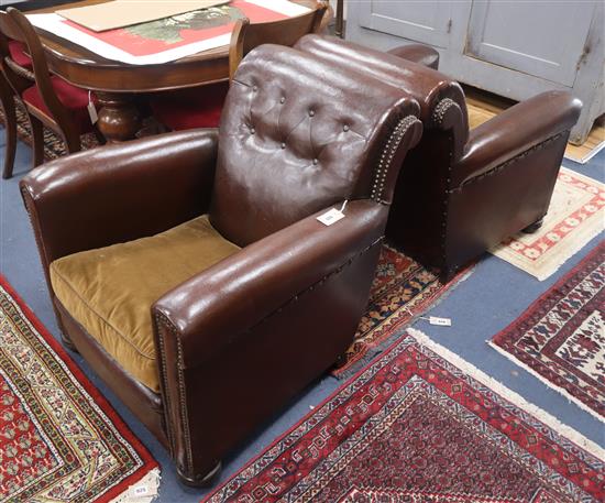 A pair of 1920s brown leather armchairs